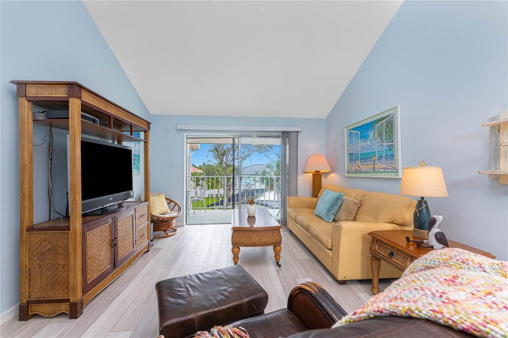 5031 North Beach Road, Unit 222 Englewood, FL 34223 - Photo 13 of 64 a living room with furniture and a flat screen tv