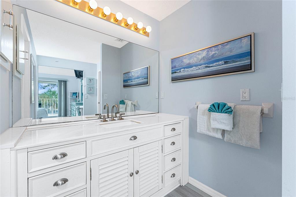 5031 North Beach Road, Unit 222 Englewood, FL 34223 - Photo 21 of 64 a bathroom with a sink mirror and window