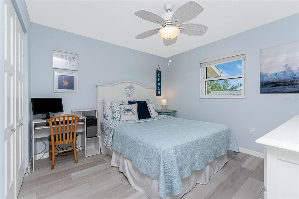 5031 North Beach Road, Unit 222 Englewood, FL 34223 - Photo 24 of 64 a bedroom with a bed and a table in it