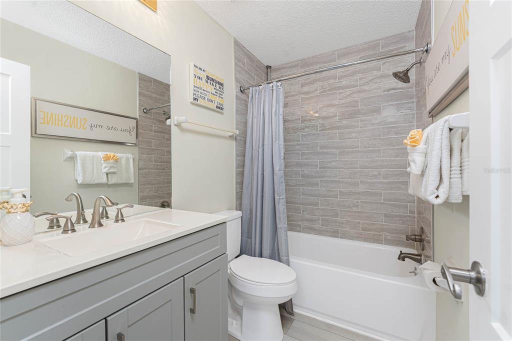 5031 North Beach Road, Unit 222 Englewood, FL 34223 - Photo 27 of 64 a bathroom with a sink toilet and shower