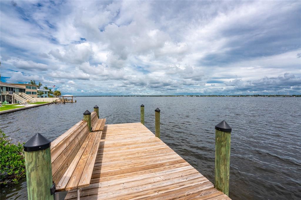 5031 North Beach Road, Unit 222 Englewood, FL 34223 - Photo 47 of 64 a view of a balcony with wooden floor and fence