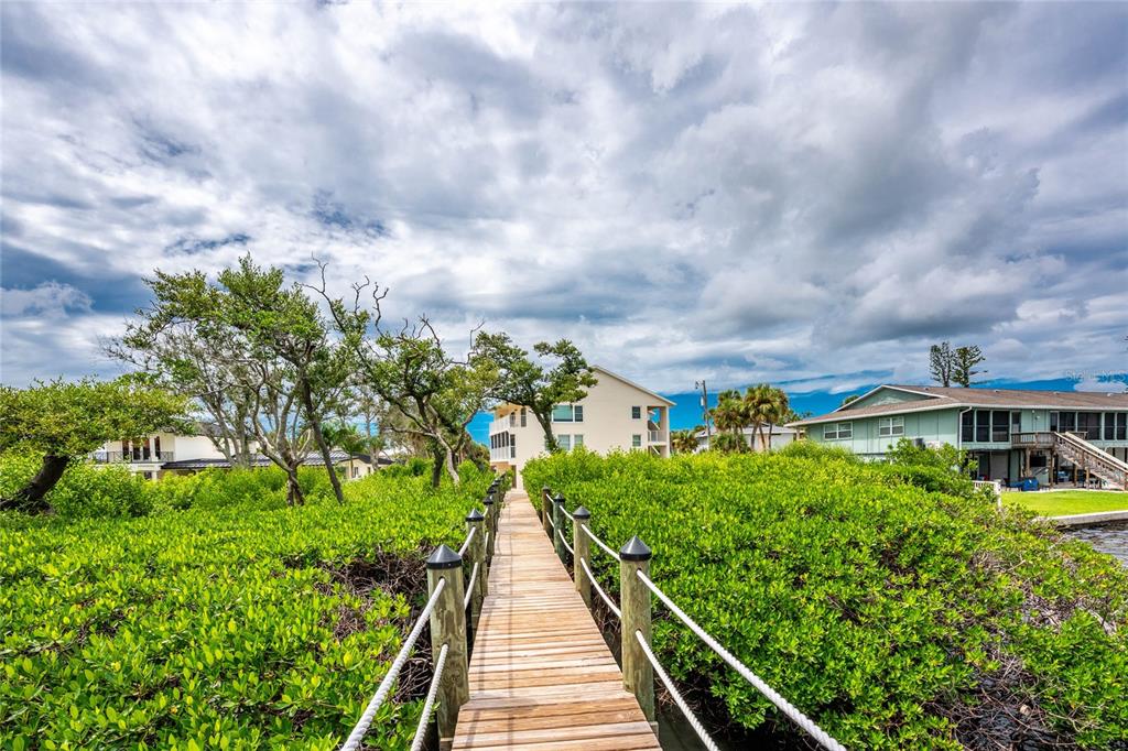 5031 North Beach Road, Unit 222 Englewood, FL 34223 - Photo 49 of 64 a view of a garden with a pathway