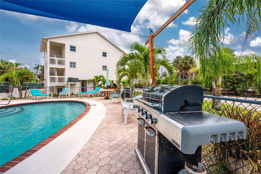 5031 North Beach Road, Unit 222 Englewood, FL 34223 - Photo 53 of 64 a view of swimming pool with outdoor seating and plants