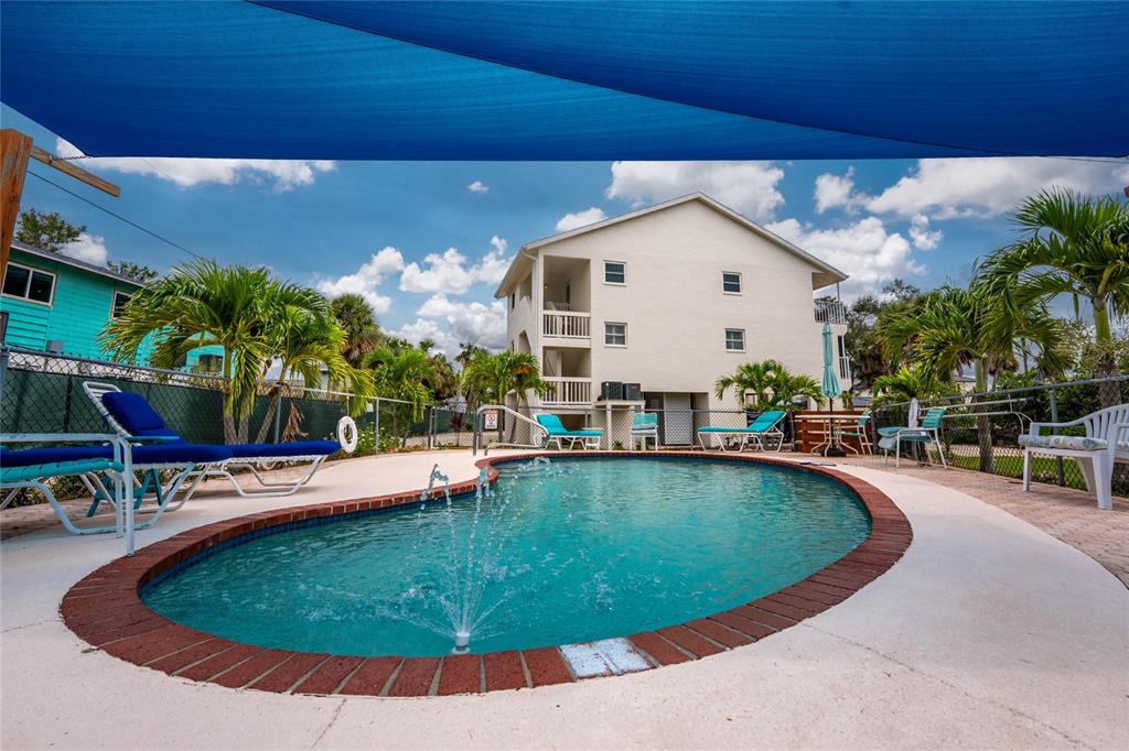 5031 North Beach Road, Unit 222 Englewood, FL 34223 - Photo 54 of 64 a view of a swimming pool with a patio