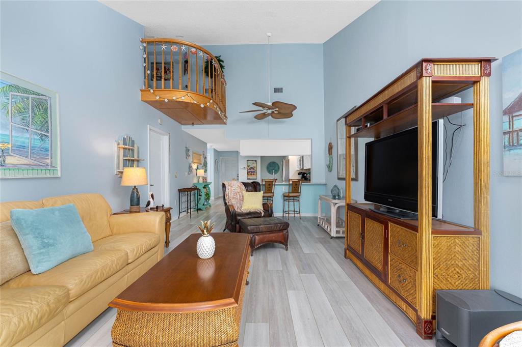 5031 North Beach Road, Unit 222 Englewood, FL 34223 - Photo 10 of 64 a living room with furniture and a flat screen tv