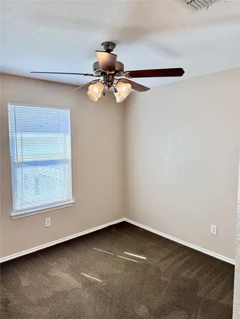 a view of room with window and ceiling fan