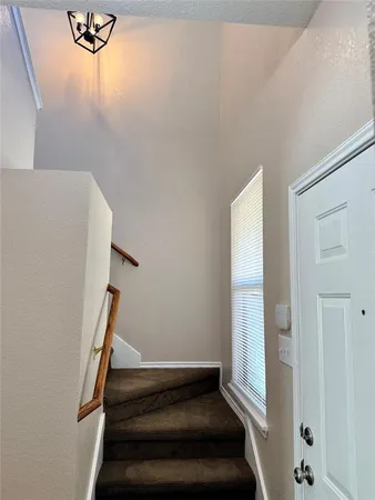 a view of staircase with white walls
