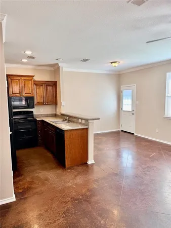 a kitchen with granite countertop a stove and cabinets