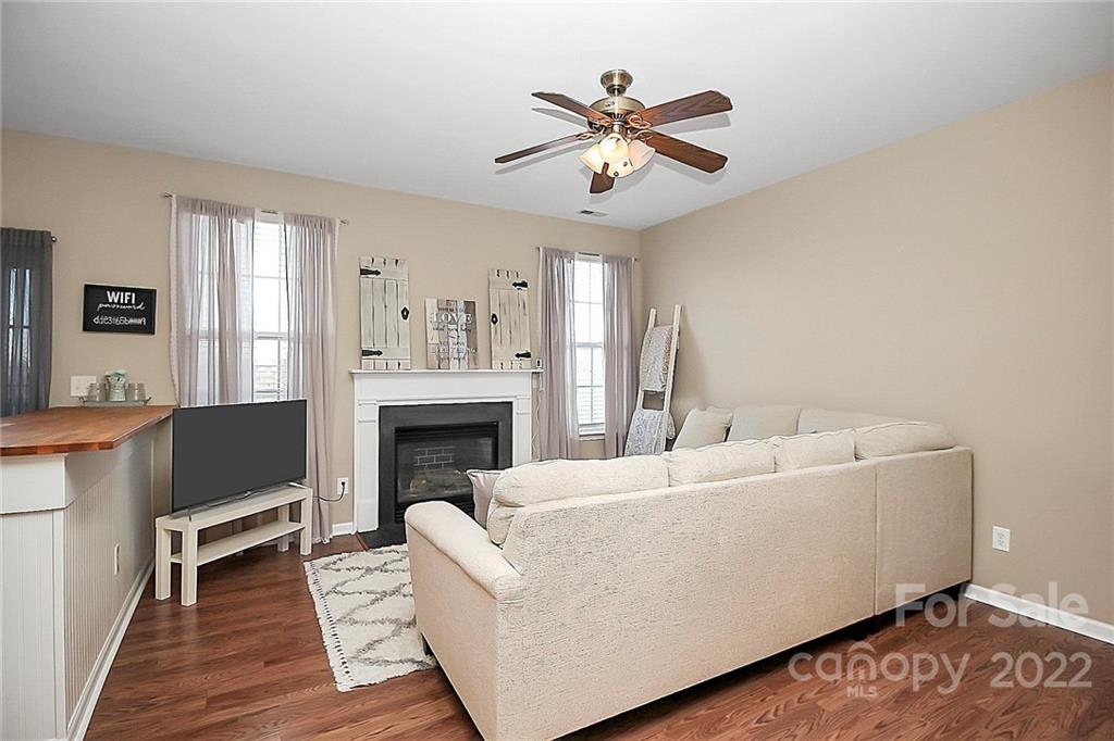 7589 Bluff Point Lane Denver, NC 28037 - Photo 13 of 36 a living room with furniture and a fireplace