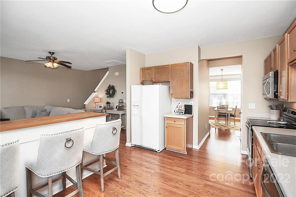 7589 Bluff Point Lane Denver, NC 28037 - Photo 15 of 36 a kitchen with a table and chairs