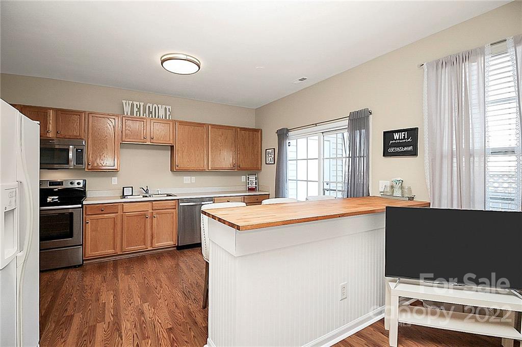 7589 Bluff Point Lane Denver, NC 28037 - Photo 19 of 36 a kitchen with a stove and a kitchen island
