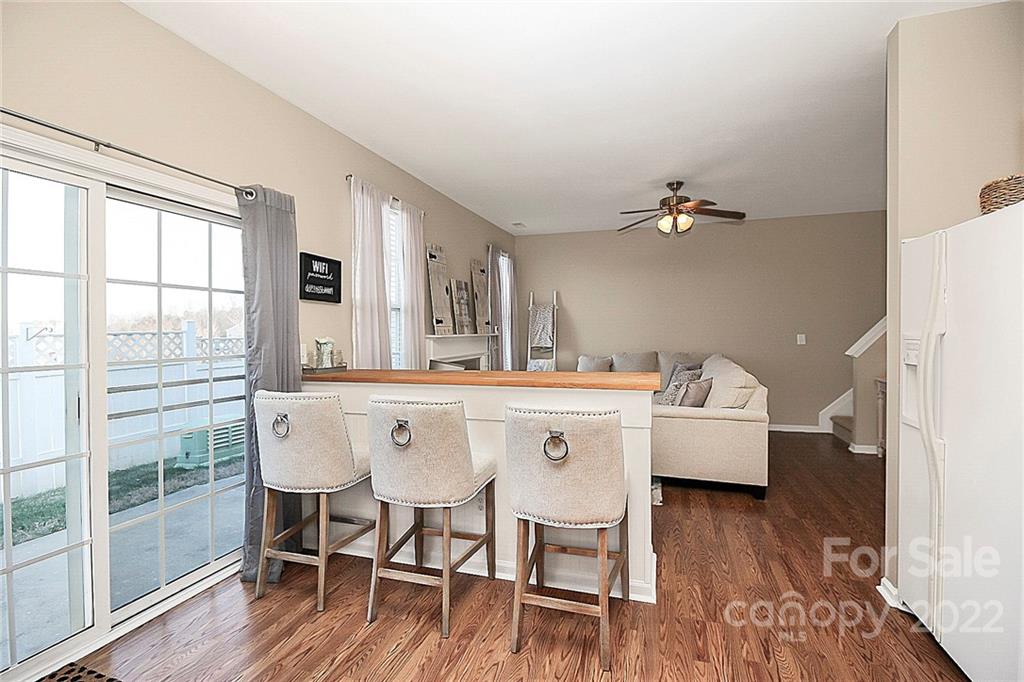 7589 Bluff Point Lane Denver, NC 28037 - Photo 20 of 36 a view of a dining room with furniture and wooden floor
