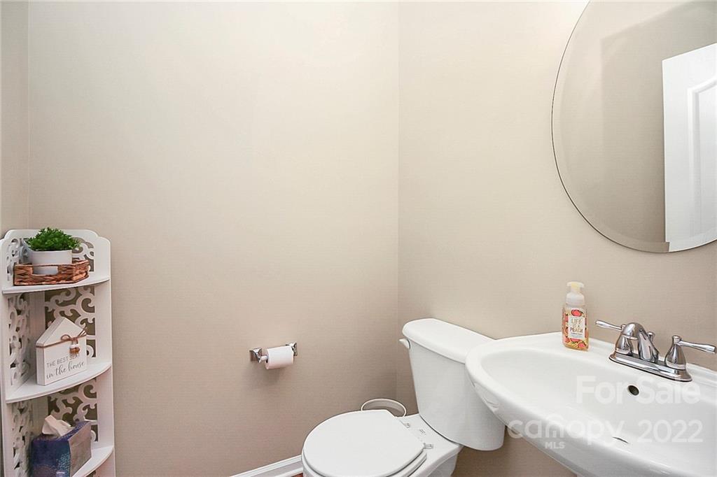 7589 Bluff Point Lane Denver, NC 28037 - Photo 21 of 36 a bathroom with a sink mirror and toilet