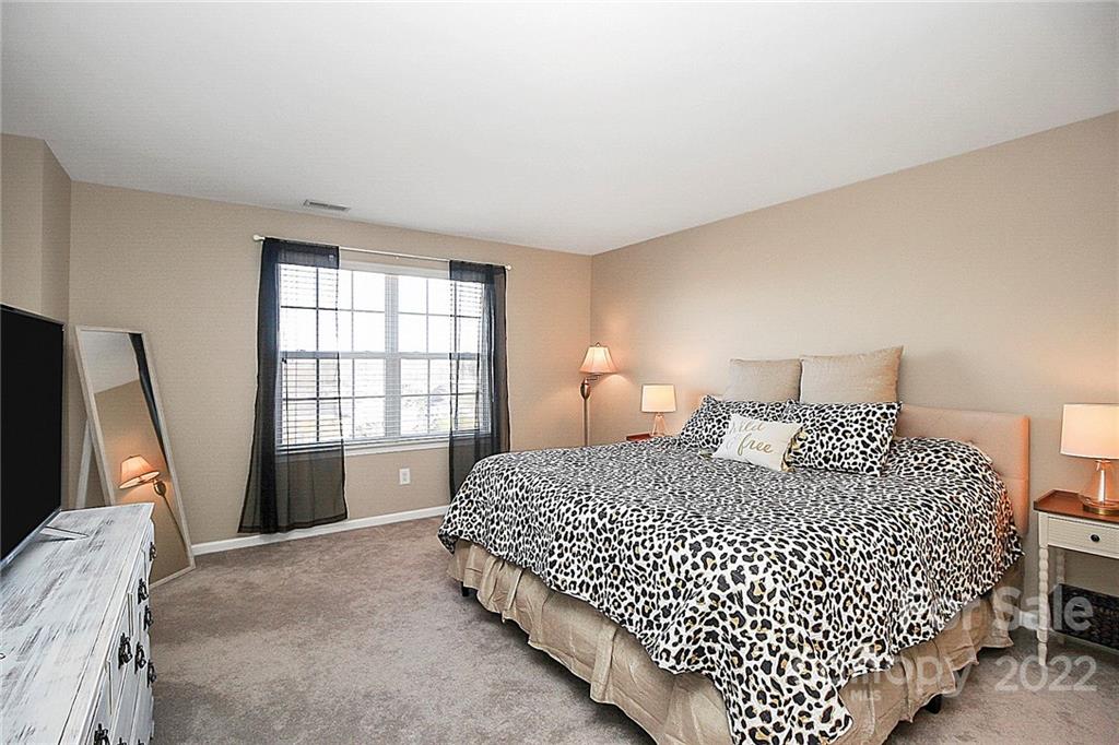 7589 Bluff Point Lane Denver, NC 28037 - Photo 22 of 36 a bedroom with bed and window