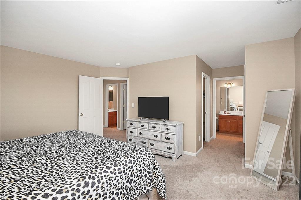 7589 Bluff Point Lane Denver, NC 28037 - Photo 24 of 36 a bedroom with a bed and a flat screen tv