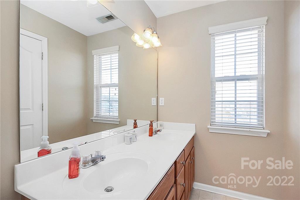 7589 Bluff Point Lane Denver, NC 28037 - Photo 25 of 36 a bathroom with a sink and a window