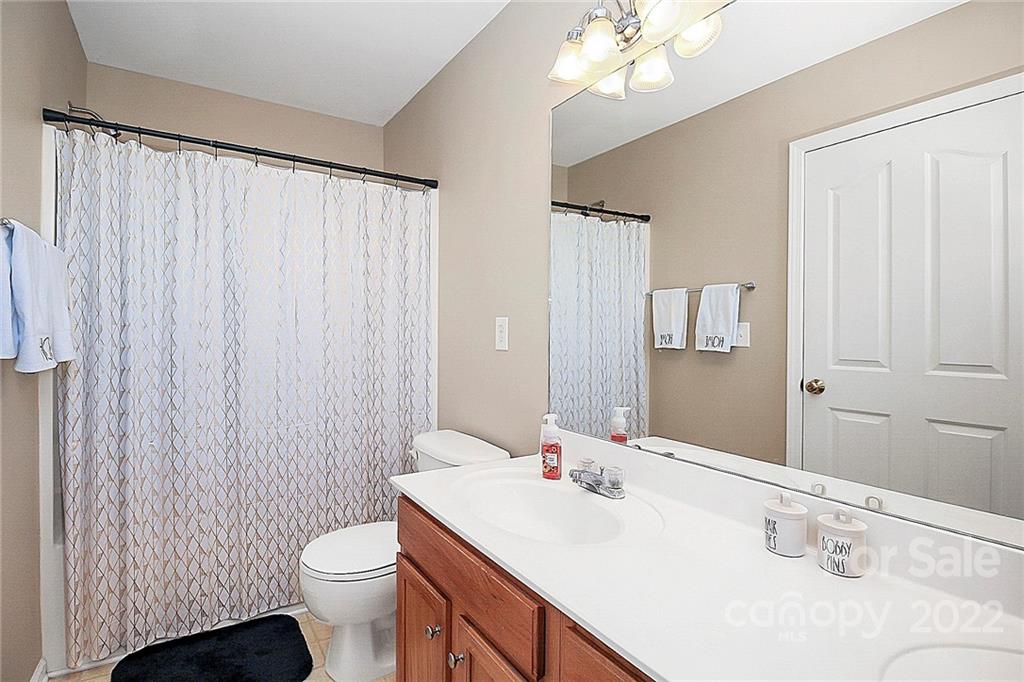 7589 Bluff Point Lane Denver, NC 28037 - Photo 26 of 36 a bathroom with a sink vanity mirror and toilet