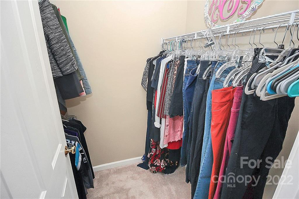 7589 Bluff Point Lane Denver, NC 28037 - Photo 27 of 36 a view of walk in closet with clothes