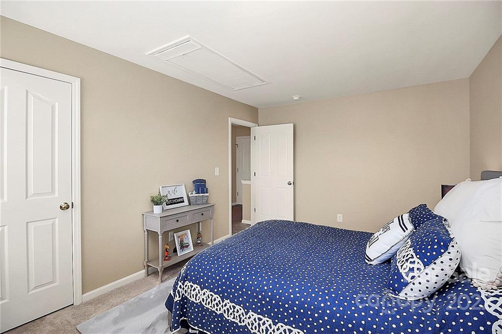 7589 Bluff Point Lane Denver, NC 28037 - Photo 28 of 36 a bedroom with a bed and cabinets