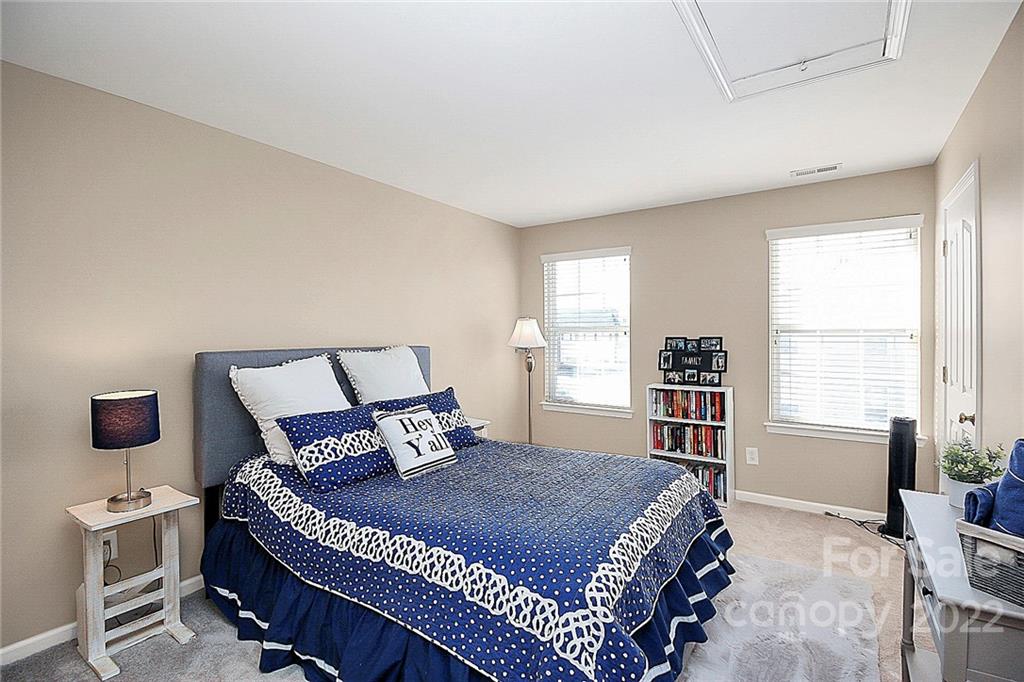 7589 Bluff Point Lane Denver, NC 28037 - Photo 29 of 36 a bedroom with a bed a chair and a window