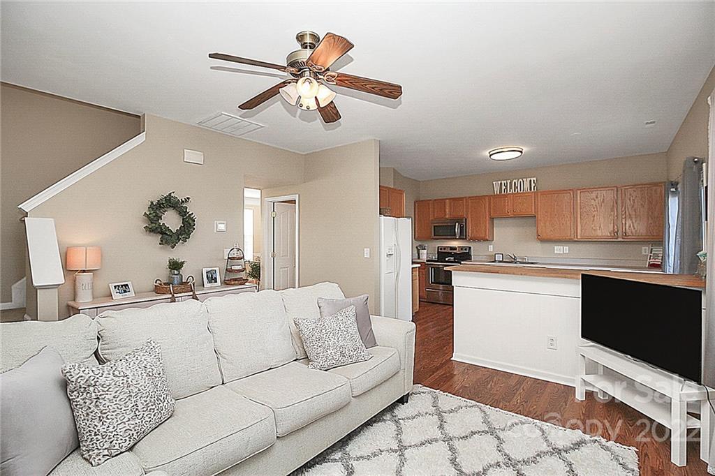 7589 Bluff Point Lane Denver, NC 28037 - Photo 10 of 36 a living room with furniture and kitchen view