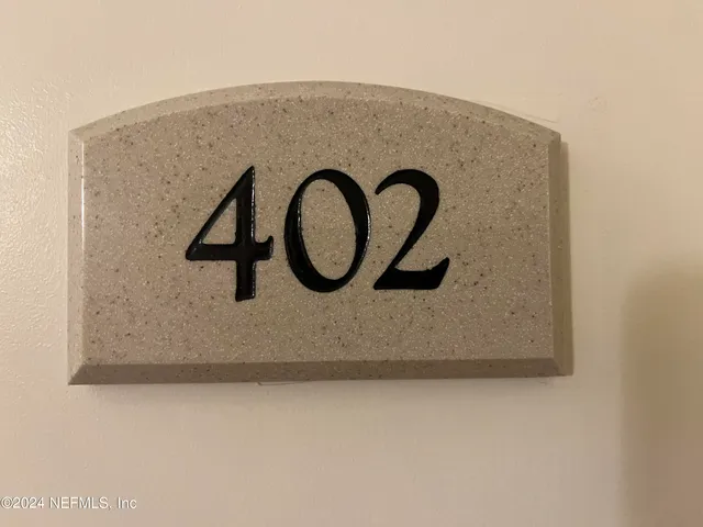 a view of a hallway with wooden floor and closet