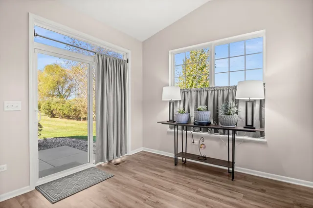 a view of workspace with wooden floor windows