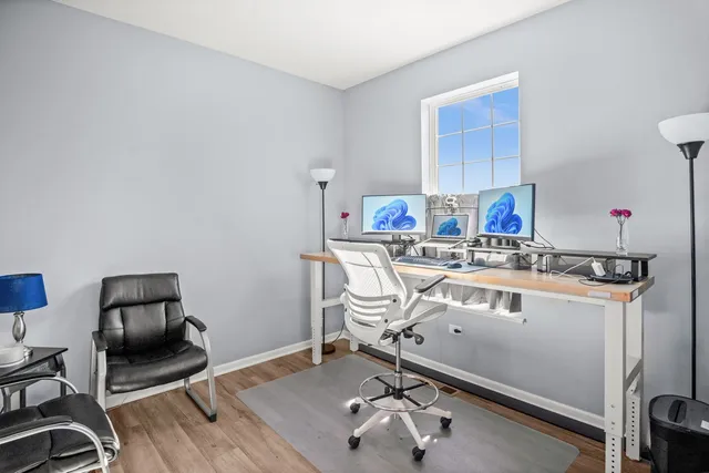 a room with a chair a rug and gym equipment