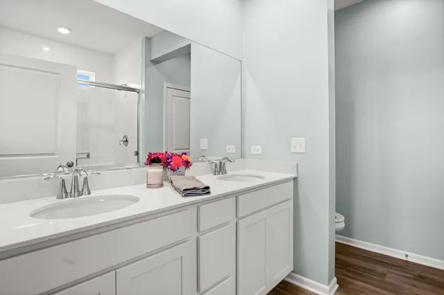 a bathroom with a double vanity sink and a mirror