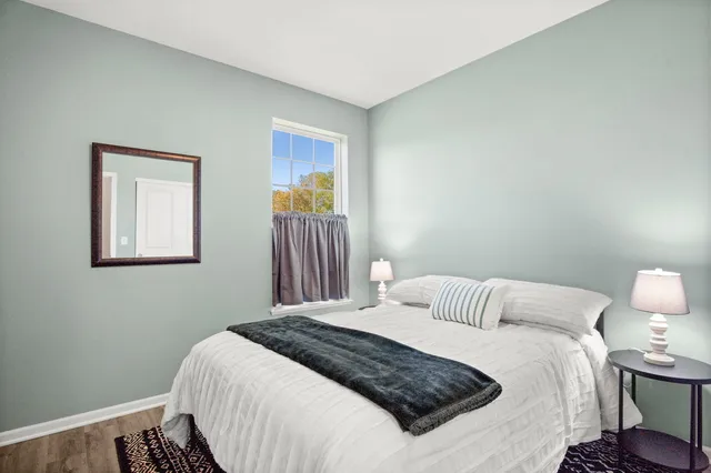 a bedroom with a bed and a lamp on table