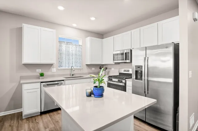 a kitchen with a refrigerator a stove and a sink