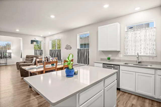 a view of a kitchen with dining table and chairs