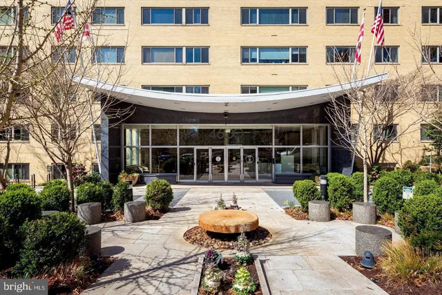 a front view of a house with sitting area and garden
