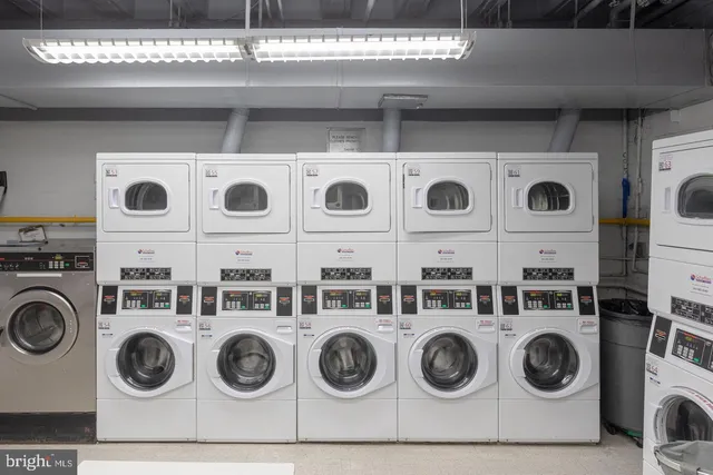 a utility room with stainless steel appliances and cabinets