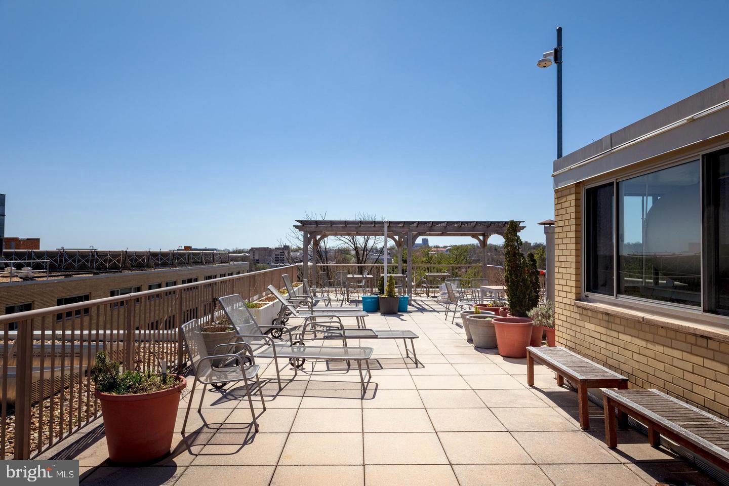 4600 Connecticut Avenue Northwest, Unit 601 Washington, DC 20008 - Photo 18 of 21 a view of a balcony with chairs and a potted plant