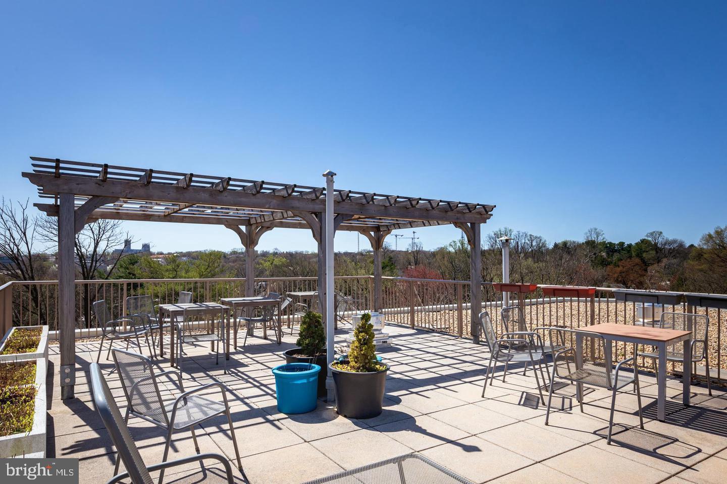 4600 Connecticut Avenue Northwest, Unit 601 Washington, DC 20008 - Photo 20 of 21 a view of a roof deck with a table and chairs