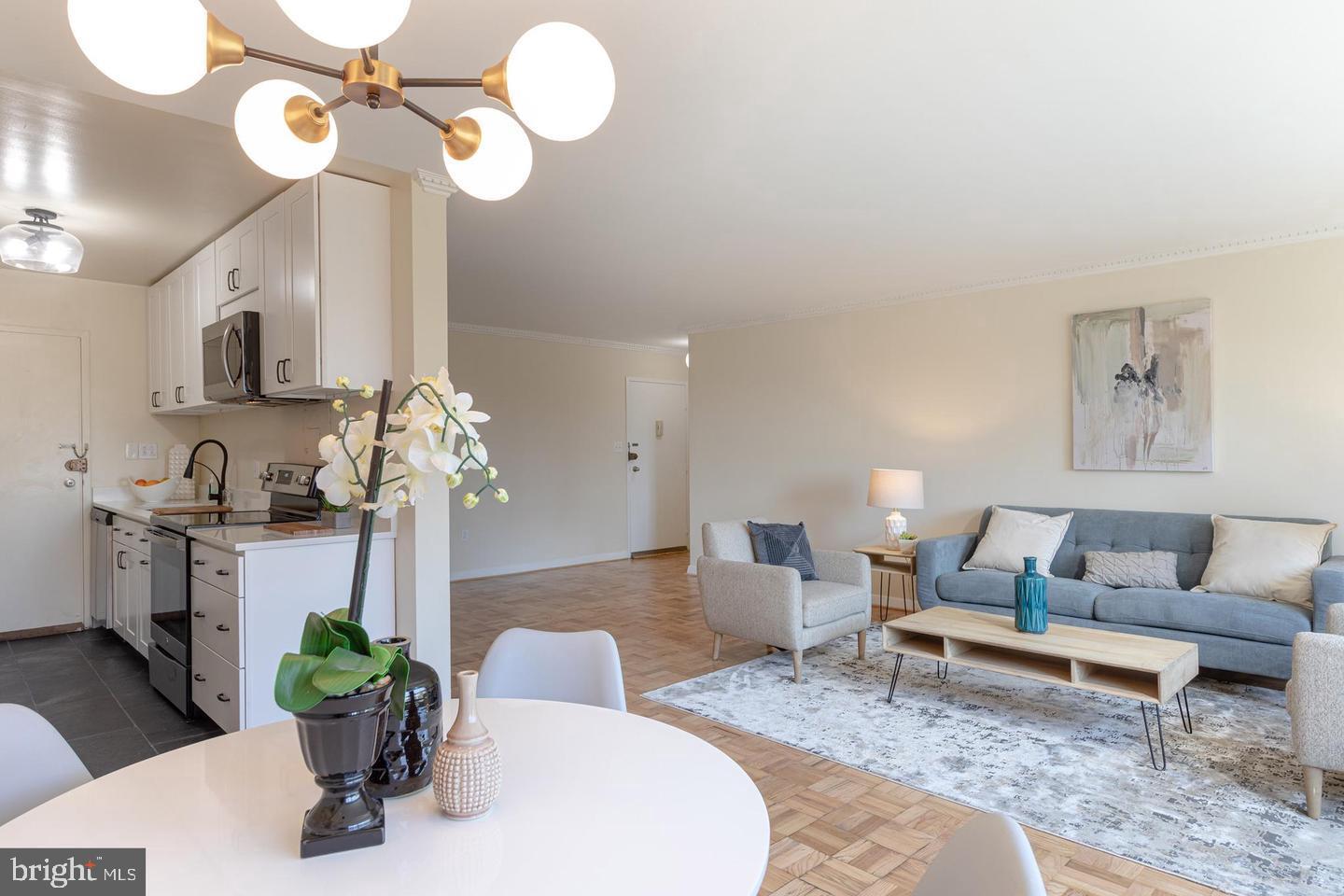 4600 Connecticut Avenue Northwest, Unit 601 Washington, DC 20008 - Photo 6 of 21 a living room with furniture flowerpot and a chandelier