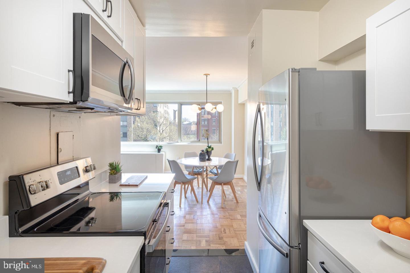 4600 Connecticut Avenue Northwest, Unit 601 Washington, DC 20008 - Photo 8 of 21 a view of a dining room with furniture window and wooden floor