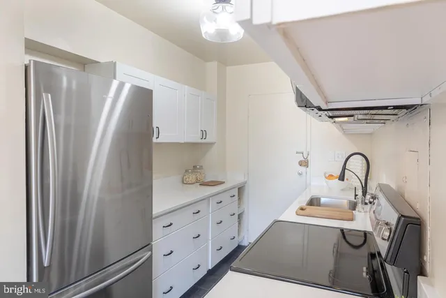 a kitchen with stainless steel appliances a refrigerator sink and cabinets