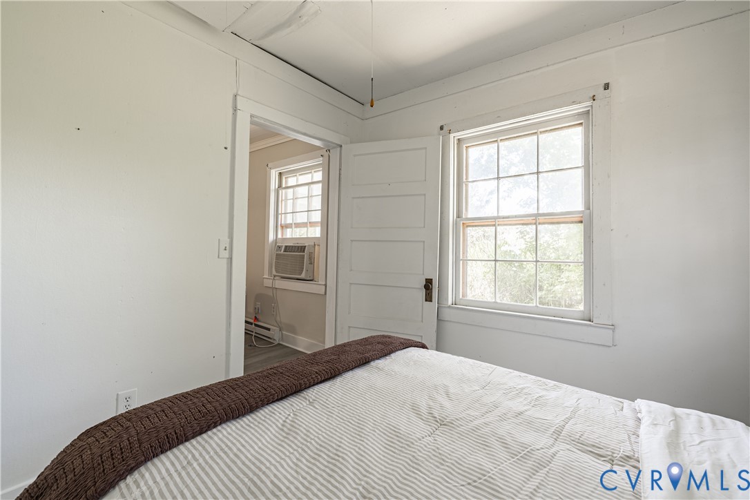933 Pleasant Point Road Surry, VA 23883 - Photo 17 of 45 a bedroom with a bed and a window
