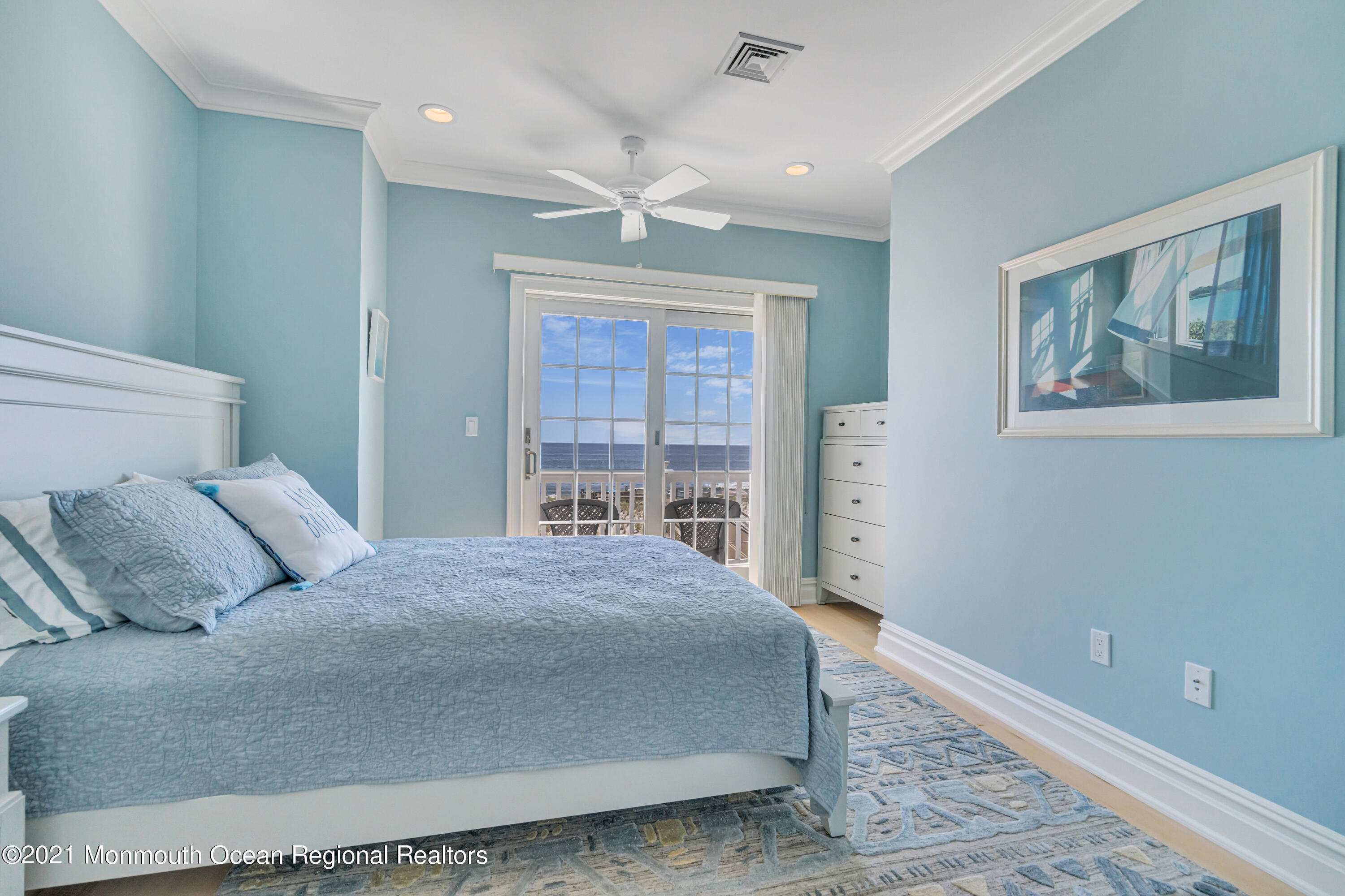 3480 Ocean Road Lavallette, NJ 08735 - Photo 54 of 83 a bedroom with a large bed and a chandelier