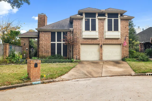 a front view of a house with a yard and a garage