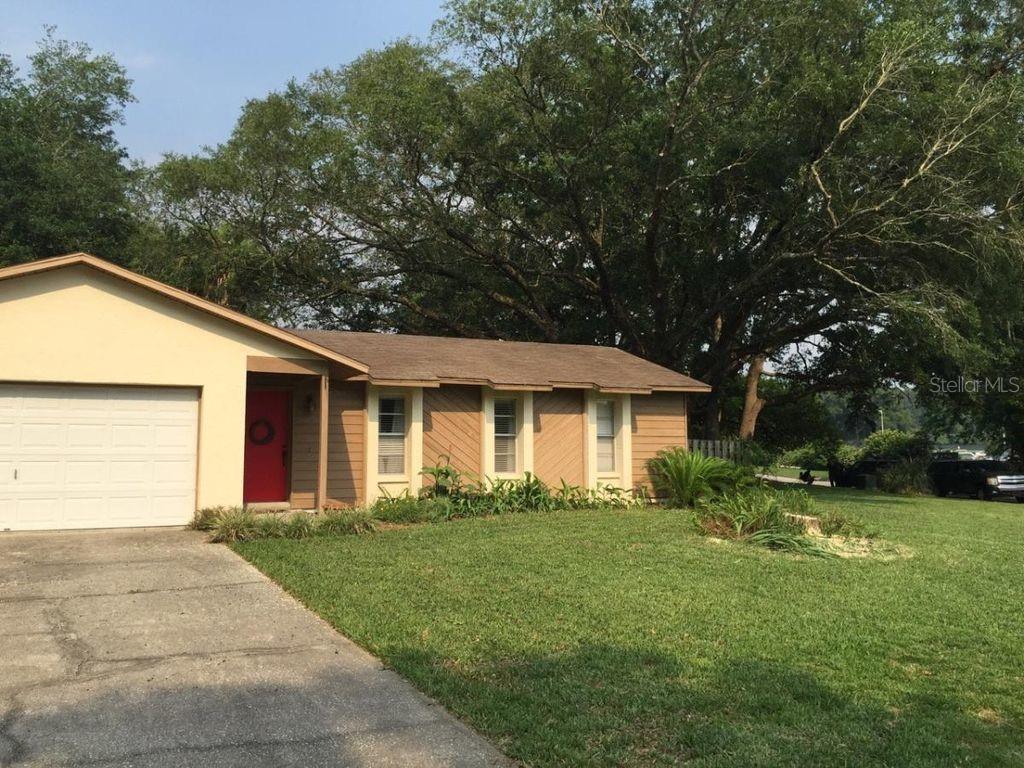 a front view of house with yard and green space