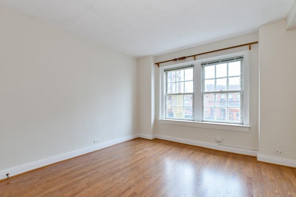 534 Beacon Street, Unit 502 Boston, MA 02215 - Photo 11 of 18 an empty room with wooden floor and windows