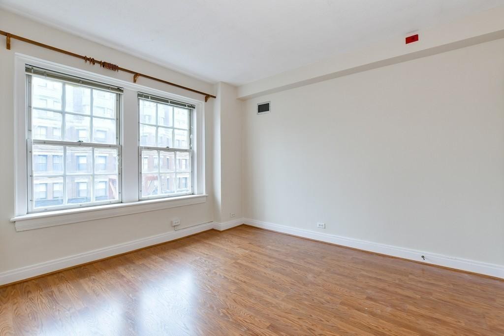 534 Beacon Street, Unit 502 Boston, MA 02215 - Photo 12 of 18 an empty room with wooden floor and windows