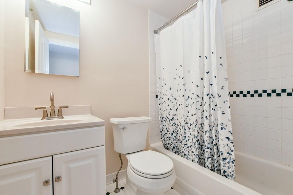 534 Beacon Street, Unit 502 Boston, MA 02215 - Photo 13 of 18 a bathroom with a sink a toilet and a mirror