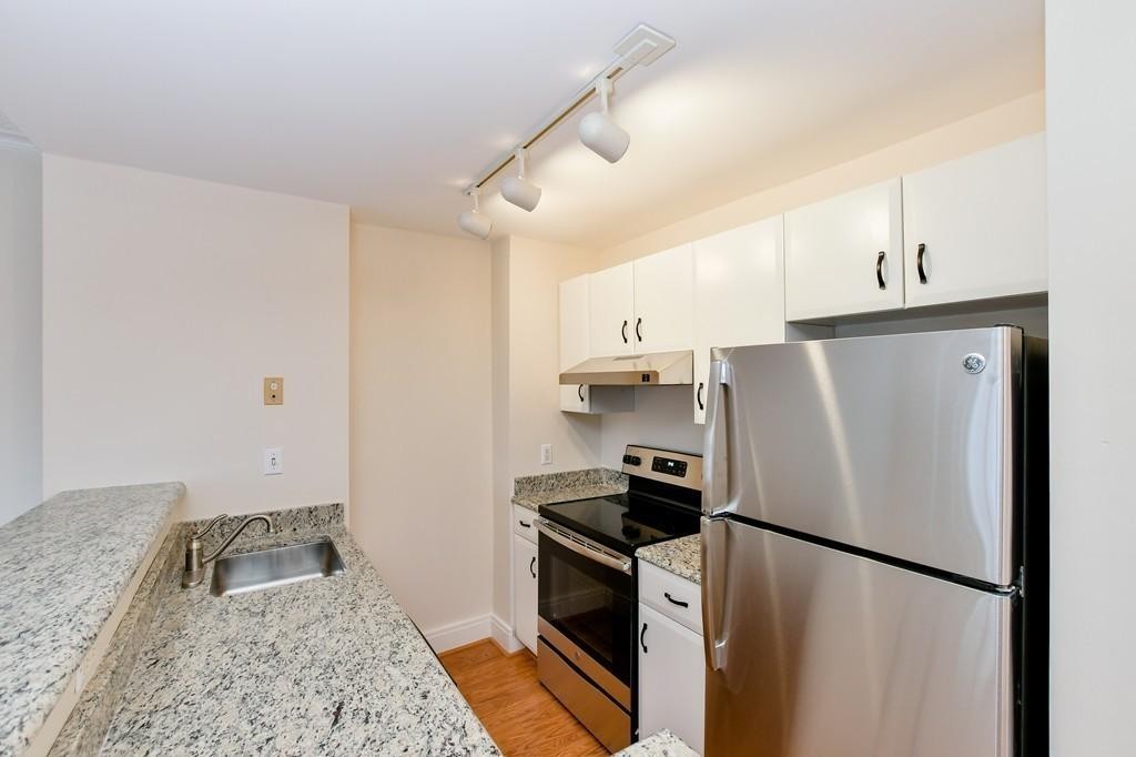 534 Beacon Street, Unit 502 Boston, MA 02215 - Photo 3 of 18 a kitchen with stainless steel appliances granite countertop a refrigerator a stove a sink and a refrigerator