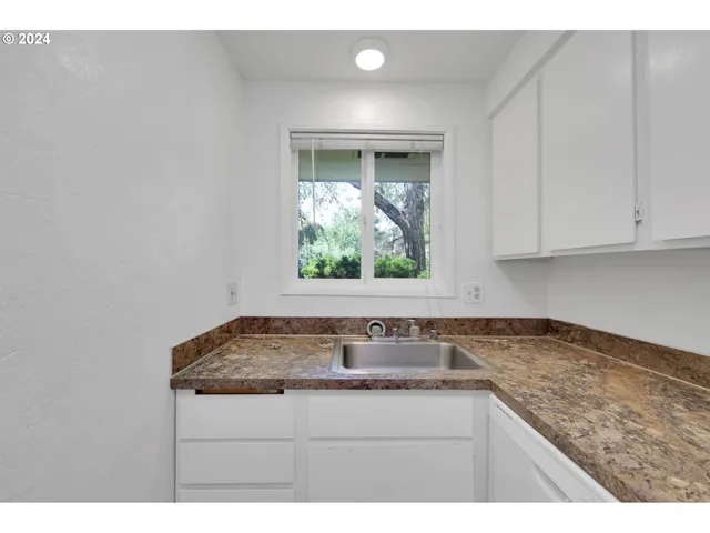 a sink with granite countertop lots of counter top space