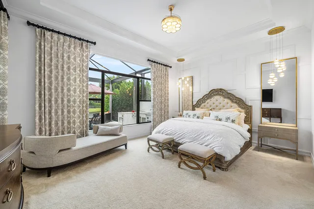 a living room with furniture a chandelier and a flat screen tv