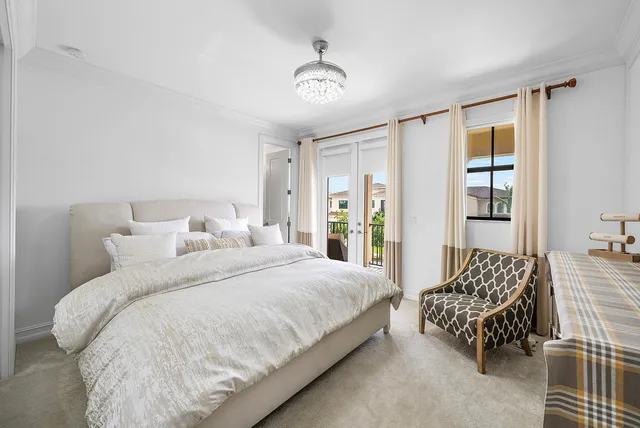 a view of a patio with a table chairs and a floor to ceiling window